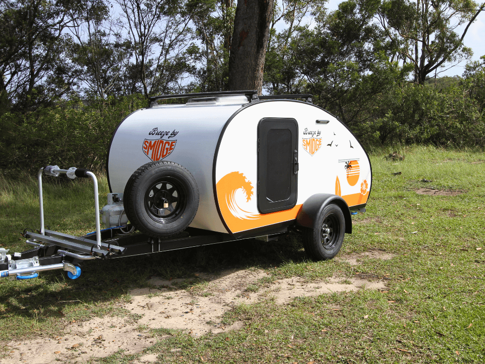 Breeze by Smidge teardrop camper trailer — front quarter left with retro surf graphics
