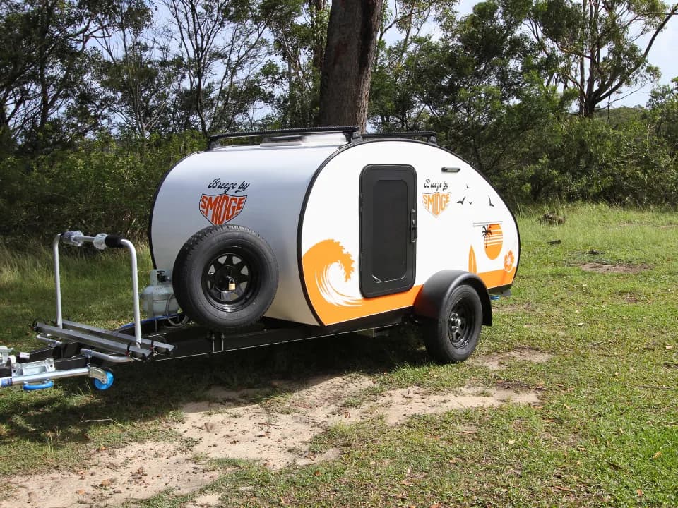 Breeze by Smidge teardrop camper trailer — front quarter left with retro surf graphics